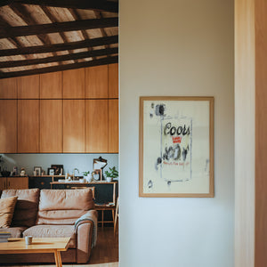 Coors Banquet bar wall art print by Betsy Crum — framed in a wood-accent room