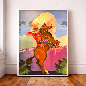 Cowboy Art Print Cowboy art print of a cowboy riding wearing a fringe shirt and star covered chaps on a bucking brown horse with a dramatic sunset in the background.  18x24" print by Artist Caya Crum, signed, cotton rag paper, archival inks.   Carl Rides Into the Sunset art print by Caya Crum shown in a neutral setting with hardwood floors and nice walls.