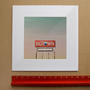 Dallas Art Prints & Gifts – Big Town Sign with Big Dallas Sky | Betsy Crum in matted square frame mockup
