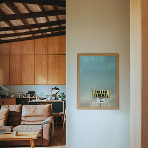 Dollar General Marfa art print by Betsy Crum — framed in a wood-accent room