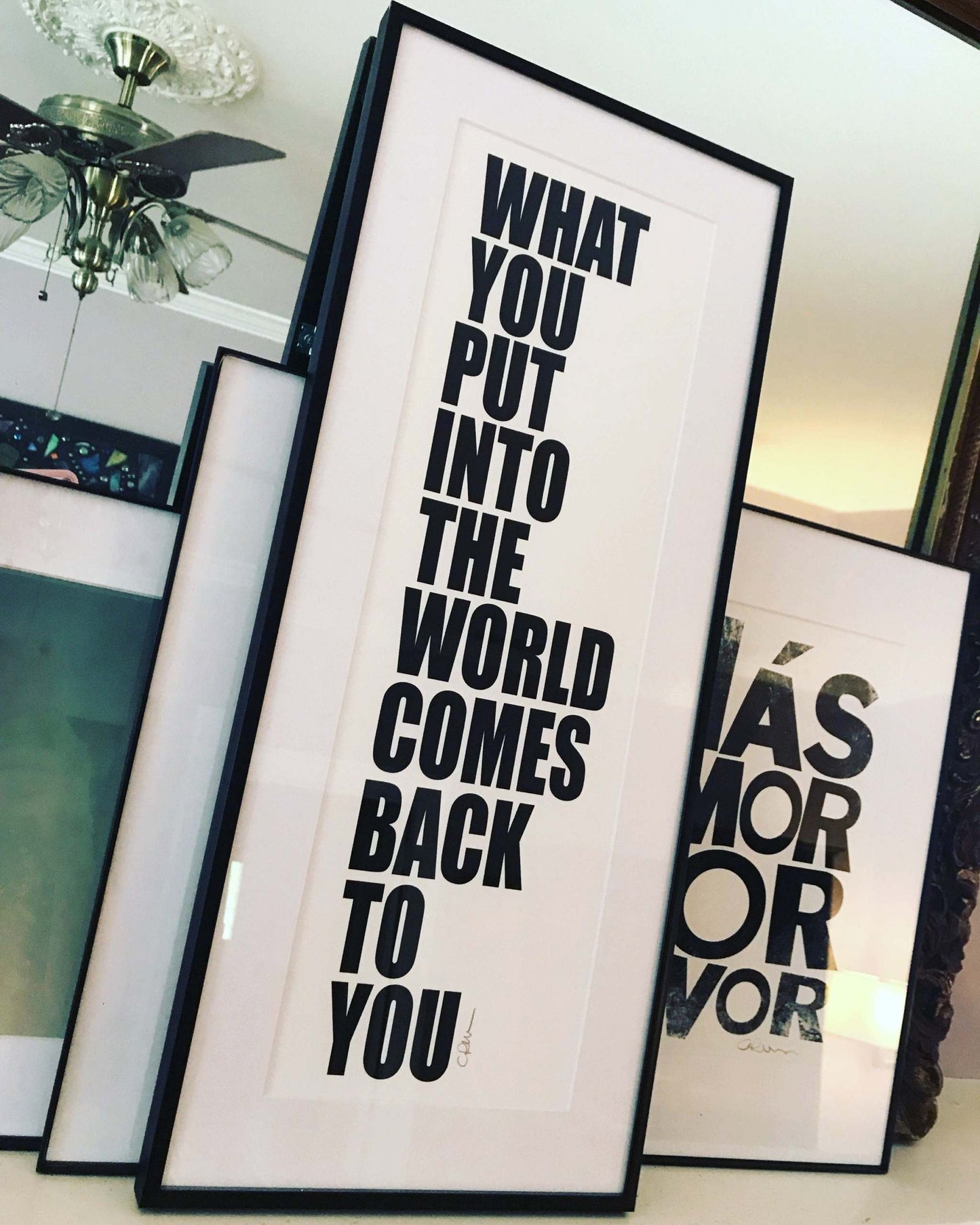 Framed John Lennon Beatles quote print "What you put into the world comes back to you" in black text on white background