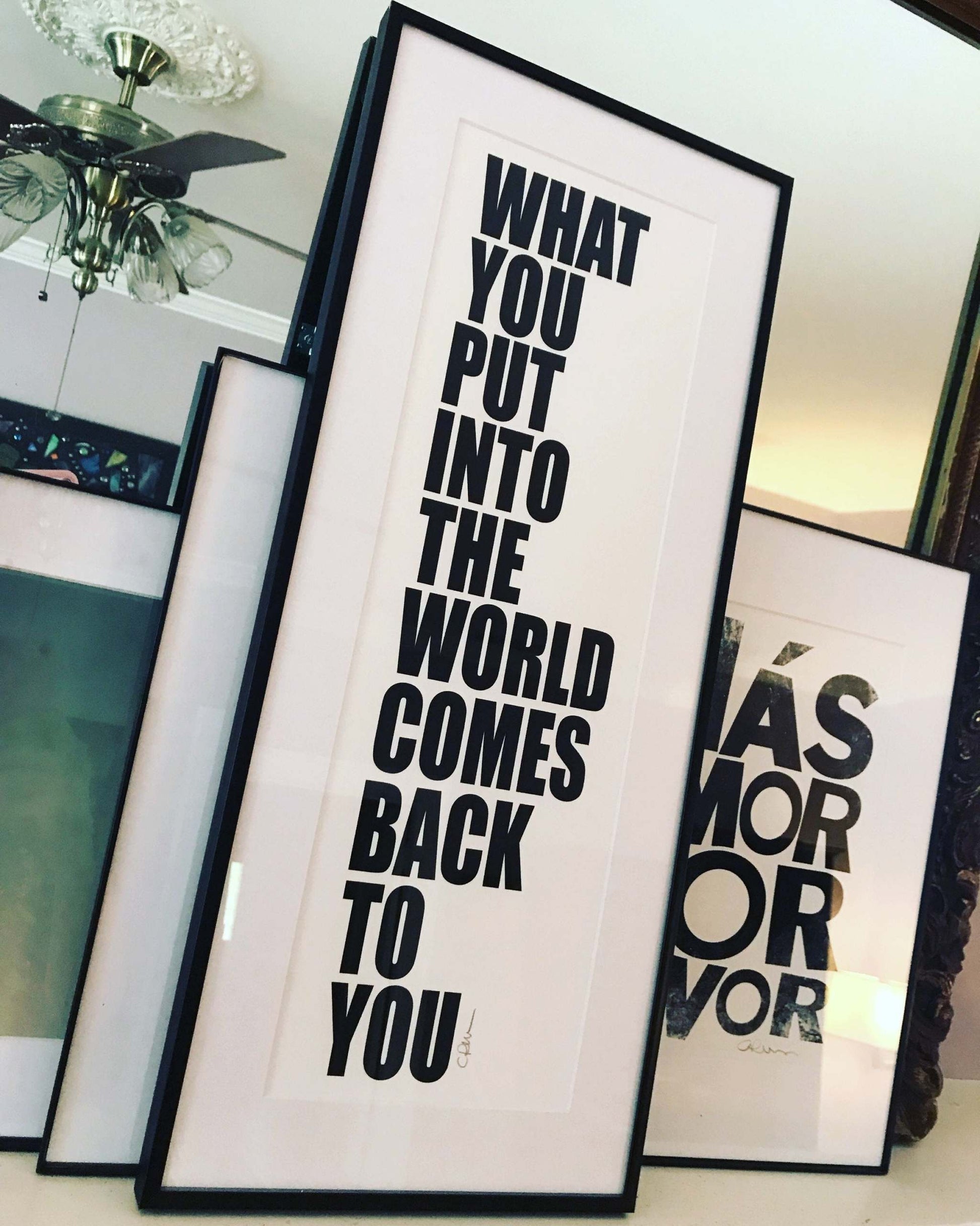 Framed John Lennon Beatles quote print "What you put into the world comes back to you" in black text on white background