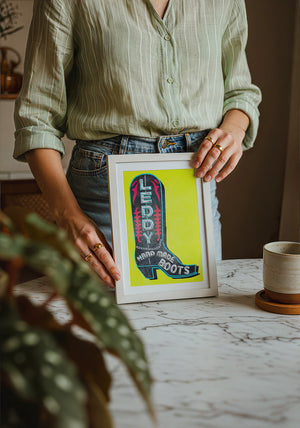 Leddy Boot Yellow cowboy boot art print by Betsy Crum — neutral frame room mockup