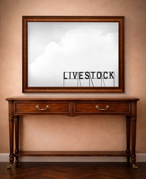 Western wall art Livestock Sign print by Betsy Crum shown horizontal in a styled room