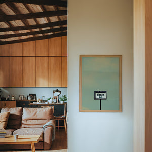 Saxon Pub Austin print by Betsy Crum — framed in a wood-accent room