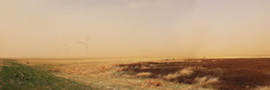 West Texas Dust Storm panoramic art print by Betsy Crum, wind turbines fading into a tan sky over gold and red pasture